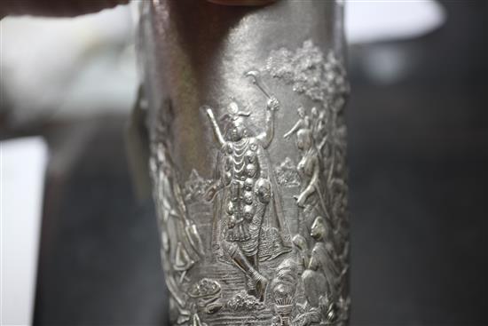 Two Indian white metal beakers, each embossed with scenes of women making offerings to Lord Shiva